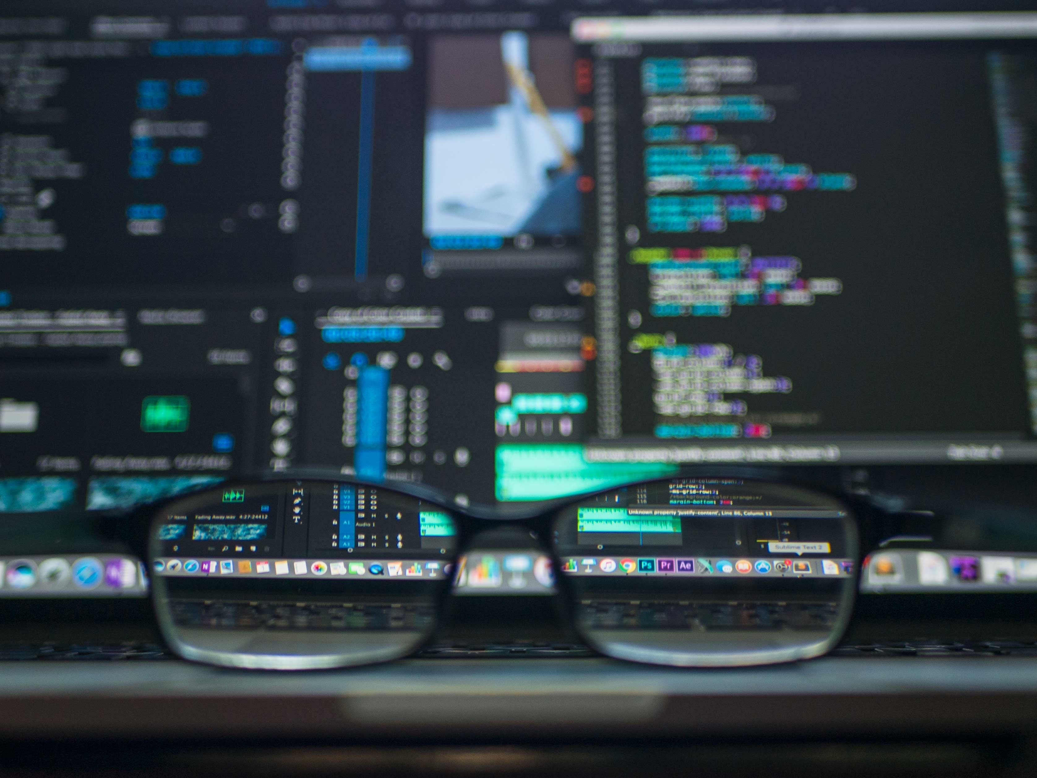 Prescription glasses in front of security source code used for artificial intelligence